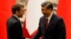 China's President Xi Jinping shakes hands with his French counterpart Emmanuel Macron after a signing ceremony in Beijing, April 6, 2023. 