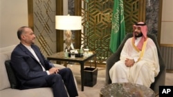 In this picture released by the Iranian Foreign Ministry, Saudi Arabia's Crown Prince Mohammed bin Salman, right, speaks with Iran's Foreign Minister Hossein Amirabdollahian in Jeddah, Saudi Arabia, Aug. 18, 2023.