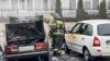 This photo released by Belgorod region governor Vyacheslav Gladkov's telegram channel on Saturday, March 16, 2024, shows emergency employees working by damaged and burned cars after shelling from the Ukrainian side, in Belgorod, Russia. 