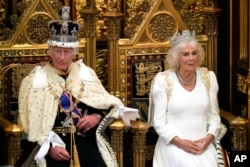 King Charles III waiting to read the King's Speech, as Queen Camilla sits beside him during the State Opening of Parliament in the House of Lords, July 17, 2024. The speech sets out the agenda of the UK's first Labour government for 14 years.