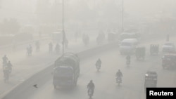 FILE - Vehicles move amid dense smog in Lahore, Pakistan, Nov. 24, 2021. According to a report published, March 14, 2023, by IQAir, a Swiss maker of air purifiers, Lahore has become the city with the worst air in the world in 2022.