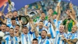Argentina's Lionel Messi holds the trophy as celebrating with teammates after defeating Colombia in the Copa America final soccer match in Miami Gardens, Florida, July 15, 2024. 