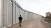 FILE - Greece's Prime Minister Kyriakos Mitsotakis walks next to a border wall near the town of Feres, along the Evros River which forms the frontier between Greece and Turkey, March 31, 2023. (Greek Prime Minister's Office via AP)