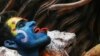 A Hindu devotee holds a snake during a religious procession on the occasion of 'Masaan' or 'Bhasma' Holi, which is celebrated with ashes of funeral pyres, in Varanasi, India, March 20, 2024.