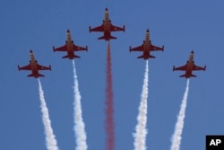 Turkey's acrobatic aircraft fly over the military parade, in the Turkish occupied area of the divided capital Nicosia, Cyprus, July 20, 2024.