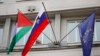 A Palestinian flag flies next to a Slovenian, center, and a European Union flag, right, at the government building in Ljubljana, Slovenia, Thursday, May 30, 2024.