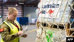 FILE - Humanitarian aid supplies are loaded on a airplane heading to Vanuatu, March 4, 2023, as part of the Australian Government's response to the Tropical Cyclones Judy and Kevin, at Amberley Base in Queensland. 