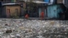 FILE - City workers remove garbage floating on the Negro River, which has a rising water level due to rain, in Manaus, Amazonas state, Brazil, June 6, 2022.