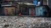 FILE - City workers remove garbage floating on the Negro River, which has a rising water level due to rain, in Manaus, Amazonas state, Brazil, June 6, 2022.