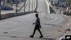 A pedestrian crosses a street free of traffic in Port-au-Prince, Haiti, March 13, 2024.