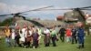 In this photo provided by the Greek Prime Minister's Office, evacuees from flooded villages arrive by helicopter at a soccer stadium, in Karditsa, Thessaly region, central Greece, Sept. 8, 2023.