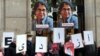 FILE - In this Jan. 13, 2022 photo, colleagues of academic Fariba Adelkhah hold placards in Paris in support following Iran's decision to send her back to prison after a period of house arrest. On Feb. 10, 2023, she was released from prison. 