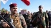 Members of an Iraqi Shiite militant group carry the coffin of a fighter with the Kataib Hezbollah militia, who was killed in a U.S. airstrike in Babil Province, during his funeral in Baghdad, Iraq, Dec. 26, 2023. 