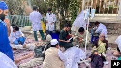In this handout photo released by MSF Afghanistan, injured people received treatment after a powerful earthquake in Herat province, western of Afghanistan, Oct. 15, 2023. (MSF Afghanistan via AP)
