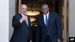 Secretary of Defense Lloyd Austin and Iraq's Minister of Defense Thabit Muhammad Al-Abbas exchange pleasantries during a brief ceremony for Al-Abbas before leaving the Pentagon, Aug. 7, 2023.