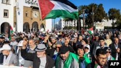 Moroccans wave Palestinian flags during a protest in Rabat on Dec. 24, 2023 in solidarity with Gaza amid the ongoing conflict between Israel and the Palestinian militant group Hamas.
