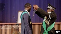 Bassirou Diomaye Faye (L) is sworn in as Senegal's President at an exhibition center in the new town of Diamniadio, near the capital Dakar on April 2, 2024. 
