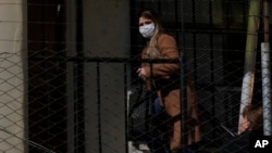 FILE - Bolivia's former interim President Jeanine Anez walks to her sentencing at the Miraflores women's jail, in La Paz, June 15, 2022.