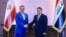 In this handout photo released by Iraq's National Security Council press office, Iraq's National Security Adviser Qasim al-Araji (R) welcomes the Secretary of Iran's Supreme National Security Council Ali Shamkhani, in Baghdad, Iraq, March 19, 2023.