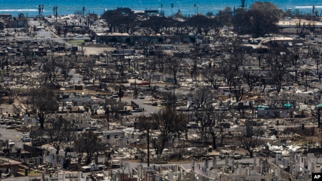 FILE - Charred remains of homes are visible following a wildfire in Lahaina, Hawaii, Aug. 22, 2023.