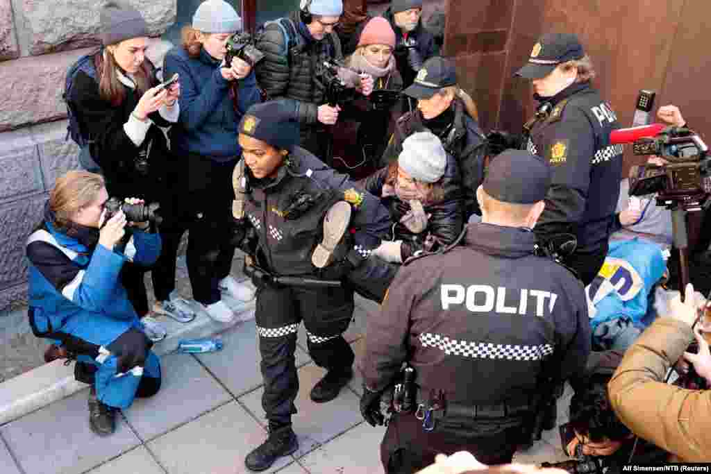 Norweigean police carry away Greta Thunberg as activists demonstrate outside the Ministry of Finance entrance and several other ministries in Oslo, Norway, in protest that the wind turbines at Fosen, which the Supreme Court has said are illegal,&nbsp;have not been taken down.