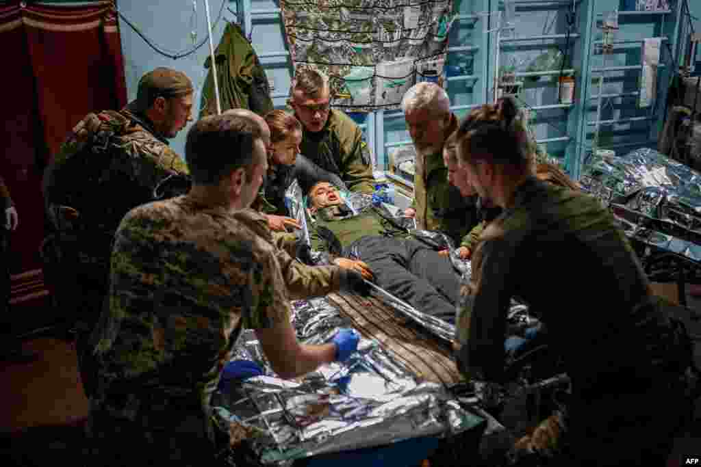 Military medics evacuate a wounded Ukrainian serviceman from a front-line medical stabilization point near the city of Bakhmut, Donetsk region, amid the Russian invasion of Ukraine. 