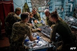 Military medics evacuate a wounded Ukrainian serviceman from a front-line medical stabilization point near the city of Bakhmut, Donetsk region, amid the Russian invasion of Ukraine.