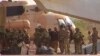 FILE - This undated photograph provided by the French military shows Russian mercenaries boarding a helicopter in northern Mali. 