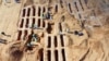 (FILE) An aerial view of the "Search and Identification of the Missing" mission unearthing a mass grave site in western Libya's Tarhuna region on November 7, 2020.