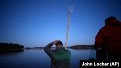 John Baker holds a spear while getting ready to fish at the Chippewa Flowage on the Lac Courte Oreilles Reservation, Sunday, April 14, 2024, near Hayward, Wisconsin. (AP Photo/John Locher)