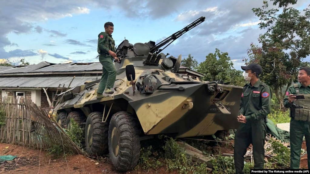 FILE - Members of an ethnic armed forces group known as the Three Brotherhood Alliance check an armored vehicle the group allegedly seized from Myanmar's army outpost on a hill in Hsenwi township in Shan state, Nov. 24, 2023.