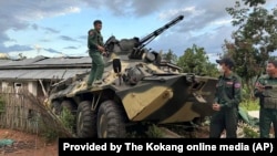 FILE - Members of an ethnic armed forces group known as the Three Brotherhood Alliance check an armored vehicle the group allegedly seized from Myanmar's army outpost on a hill in Hsenwi township in Shan state, Nov. 24, 2023.
