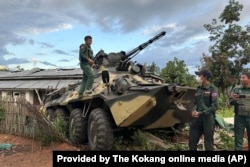 FILE - Members of an ethnic armed forces group known as the Three Brotherhood Alliance check an army armored vehicle the group allegedly seized from Myanmar's army outpost on a hill in Hsenwi township in Shan state on Nov. 24, 2023.