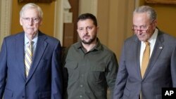Ukrainian President Volodymyr Zelenskyy, center, walks with Senate Minority Leader Mitch McConnell, left, and Senate Majority Leader Chuck Schumer on Capitol Hill in Washington, Sept. 21, 2023.