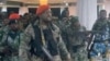 A man in military fatigues speaks as others stand behind him inside the Palace of the Nation during an attempted coup, in Kinshasa, Democratic Republic of Congo, May 19, 2024 in this screen grab from a social media video. (Christian Malanga/Handout via Reuters) 