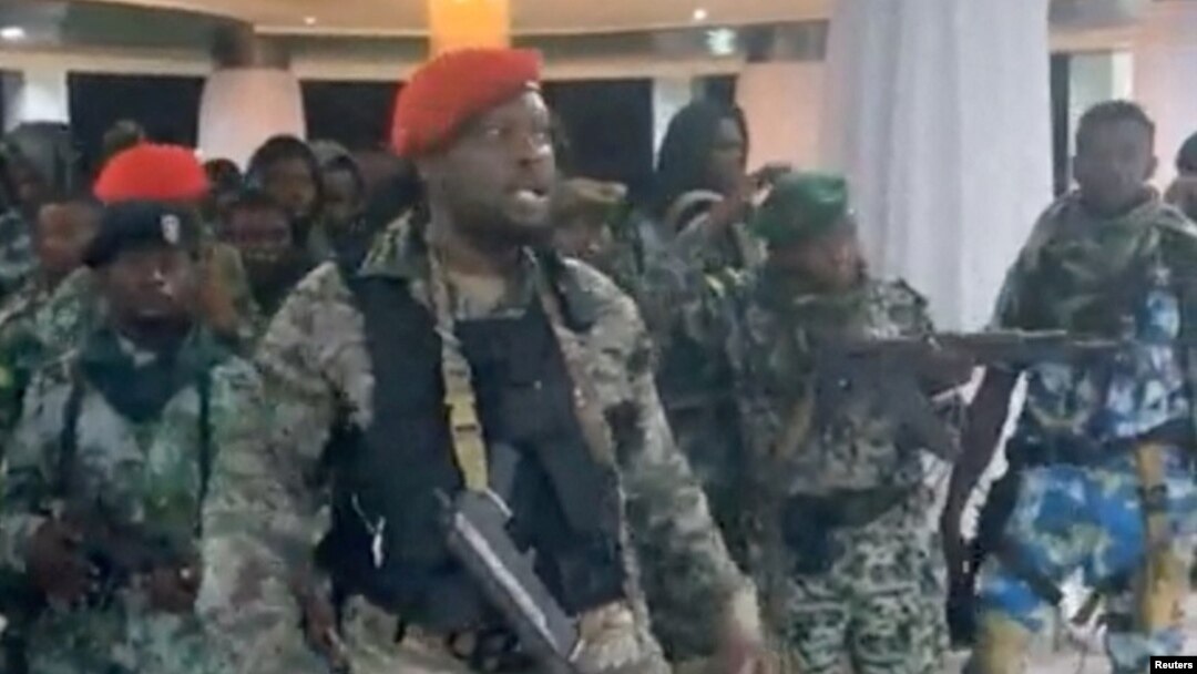A man in military fatigues speaks as others stand behind him inside the Palace of the Nation during an attempted coup, in Kinshasa, Democratic Republic of Congo, May 19, 2024 in this screen grab from a social media video. (Christian Malanga/Handout via Reuters) 