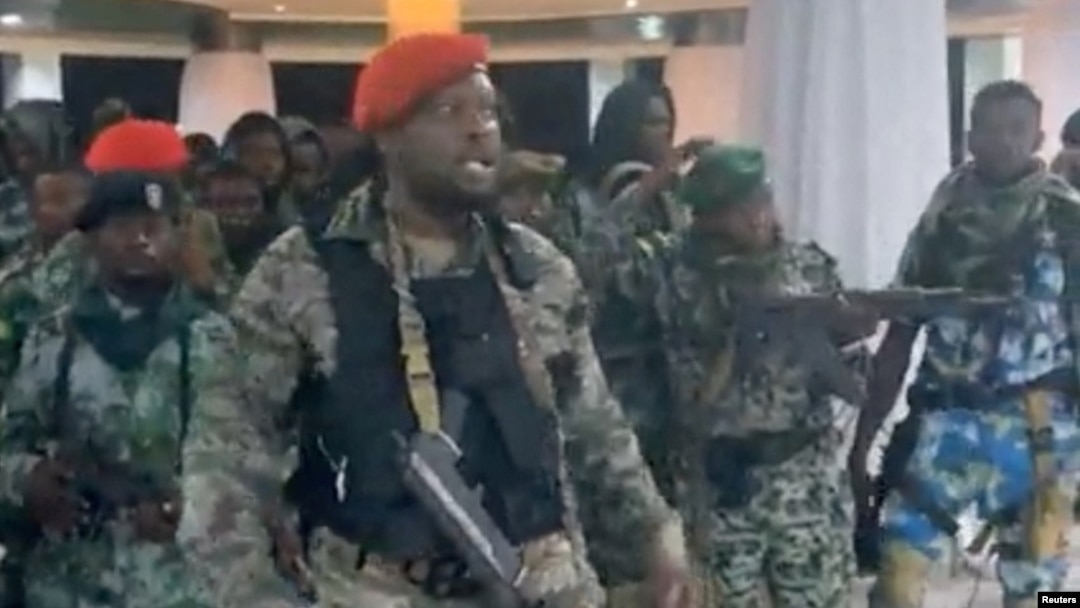 A man in military fatigues speaks as others stand behind him inside the Palace of the Nation during an attempted coup, in Kinshasa, Democratic Republic of Congo, May 19, 2024 in this screen grab from a social media video.