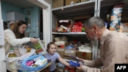 Refugees receive humanitarian aid from a collection station in Moscow on Aug. 13, 2024, following Ukraine's offensive into Russia's western Kursk region. On Aug. 6, 2024, Ukraine launched a surprise offensive into the Russian border region of Kursk.