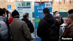 寻找工作的中国年轻人参加北京举行的一个招聘会 (2023年2月16日)