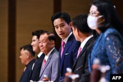 FILE - Move Forward Party leader and prime ministerial candidate Pita Limjaroenrat and coalition partners arrive at the signing ceremony for a memorandum of understanding amongst political parties in agreement to form a new government, in Bangkok, May 22, 2023.