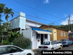The solar panels that rest on the roof of the Perez barbershop in Adjuntas, Puerto Rico, provide enough voltage to power the entire business. (Salome Ramirez/VOA)