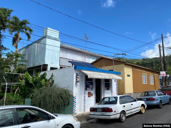 The solar panels that rest on the roof of the Perez barbershop in Adjuntas, Puerto Rico, provide enough voltage to power the entire business. (Salome Ramirez/VOA)