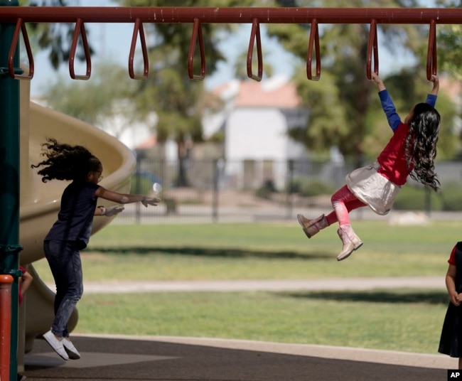 FILE - Elementary school students play on the last day of classes at Frye Elementary School in Chandler, Arizona work on their end of the year digest Tuesday, May 23, 2023.(AP Photo/Darryl Webb)