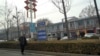 FILE - A man walks along the road in the city of Handan in northern China's Hebei province on Feb. 28, 2024. 