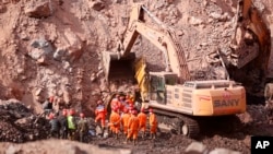 FILE — In this photo released by China's Xinhua News Agency, rescuers search a collapsed open pit coal mine in northern China's Inner Mongolia Autonomous Region, Feb. 23, 2023. An accident at a coal mine in China's Henan Province left at least 10 dead, state media said Saturday. 