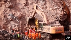 In this photo released by China's Xinhua News Agency, rescuers work at the site of a collapsed open pit coal mine in Alxa League in northern China's Inner Mongolia Autonomous Region, Feb. 23, 2023.