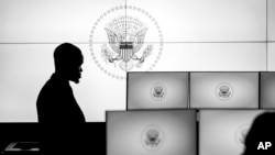 In this image provided by the White House, a person stands on the "watch floor," a 24-7 operations center that is part of newly renewed complex of the White House Situation Room at the White House, Aug. 16, 2023.