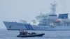 FILE - A Philippine Coast Guard rigid hull inflatable boat passes by the Japanese Coast Guard Akitsushima during a trilateral Coast Guard drill of the U.S., Japan and Philippines near the waters of the disputed South China See in Bataan province, Philippines, June 6, 2023.