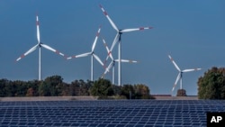 FILE - Wind turbines at a solar farm in Rapshagen, Germany, Oct. 28, 2021. Germany closes its last nuclear power plants, April 15, 2023, as it transitions to solar, wind energy.