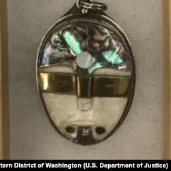A mother-of-pearl and bone mask pendant by Seattle artist Jerry Chris Van Dyke (aka Jerry Witten) who falsely claimed to be Native American.